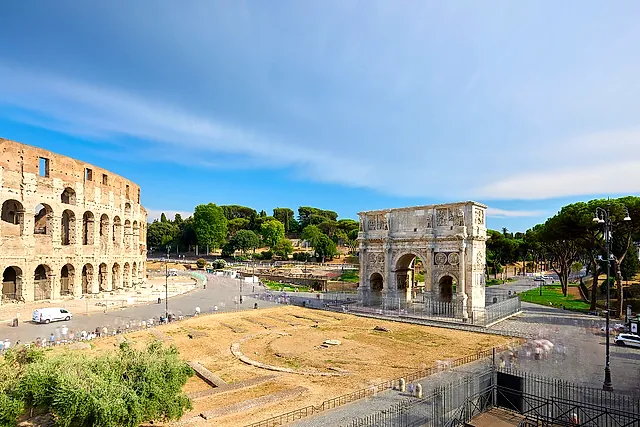 The Colosseum and the Arch of Constantine under a clear blue sky